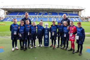 Junior grassroots football team at stadium